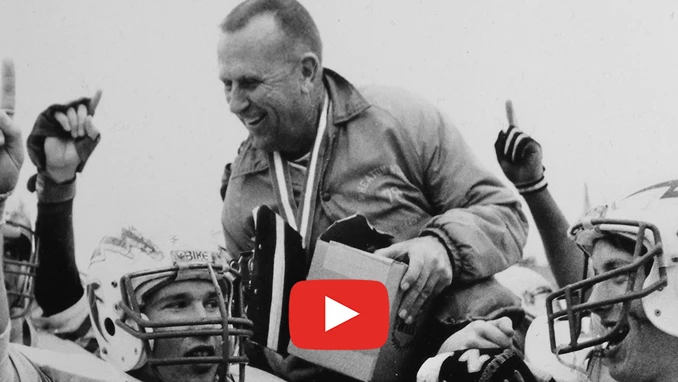Image of Coach Rex on players' shoulders